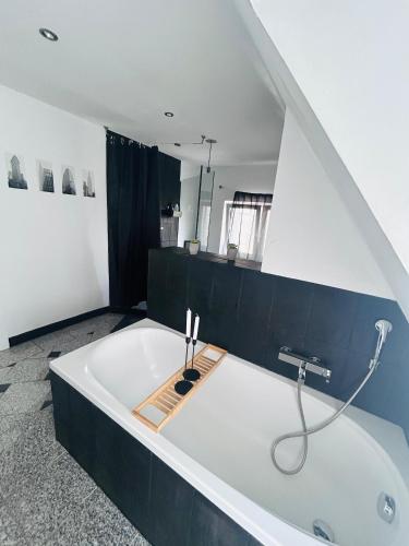 a large white bath tub in a bathroom at Ferien- Monteurwohnung in Bielefeld