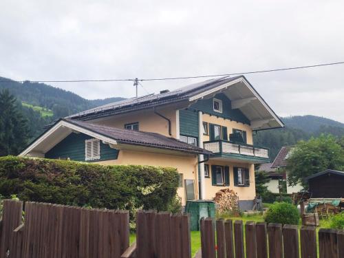 a house with a fence in front of it at Gästehaus Fuchs in Gröbming