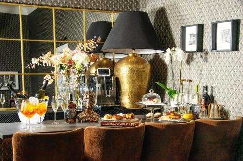 a table with plates of food and a lamp at STOA ROME Boutique Suites in Rome