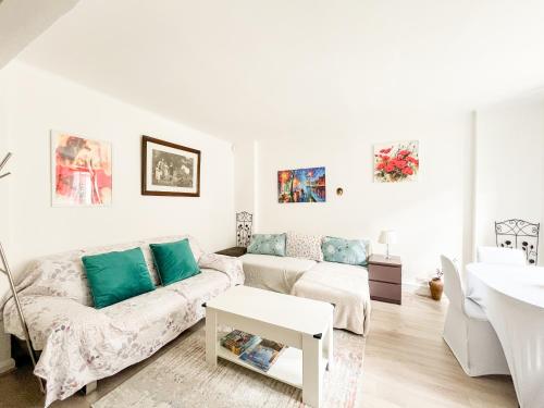 a white living room with a couch and a table at Regents Park Camden St Johns Wood in London