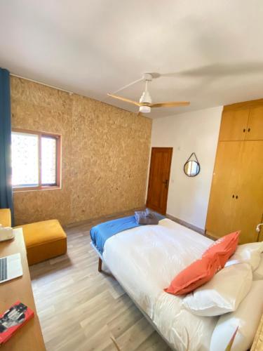 a bedroom with a large white bed and a table at Pink Lemon House in Elche