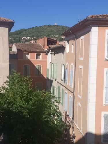 a group of buildings with green shutters on them at le sept 2 in Manosque