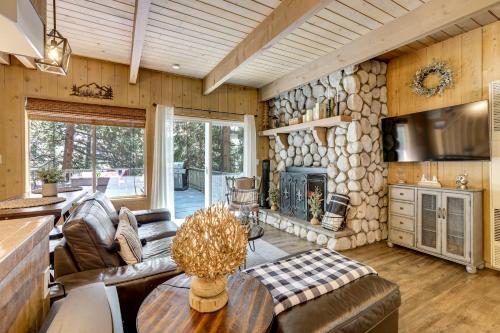 a living room with a large stone wall at 2 Mi to Lake Arrowhead Pet-Friendly Cabin in Lake Arrowhead