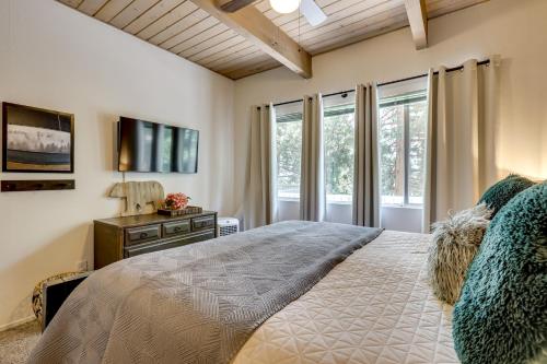 a bedroom with a large bed and a window at 2 Mi to Lake Arrowhead Pet-Friendly Cabin in Lake Arrowhead