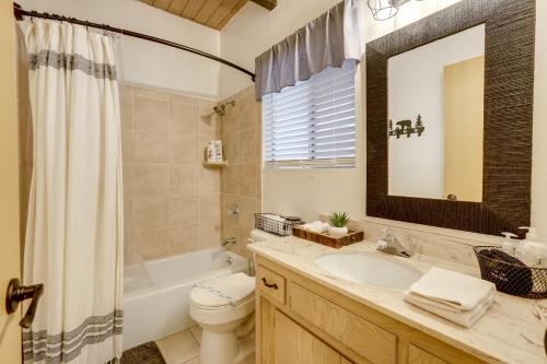 a bathroom with a sink and a toilet and a mirror at 2 Mi to Lake Arrowhead Pet-Friendly Cabin in Lake Arrowhead