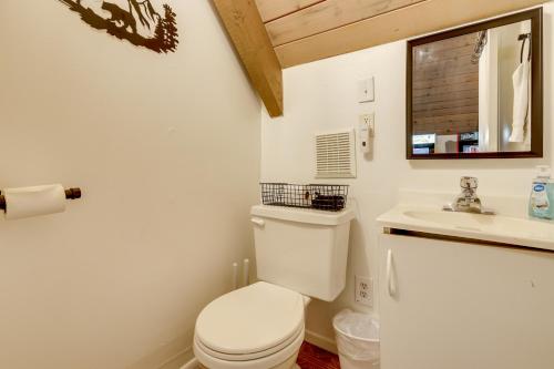 a bathroom with a white toilet and a sink at 2 Mi to Lake Arrowhead Pet-Friendly Cabin in Lake Arrowhead