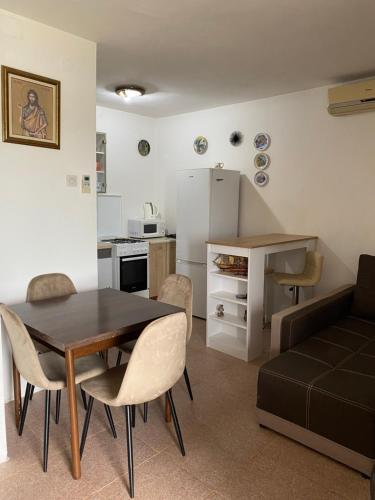 a kitchen and living room with a table and a couch at Bigova Peace Oasis in Bigovo