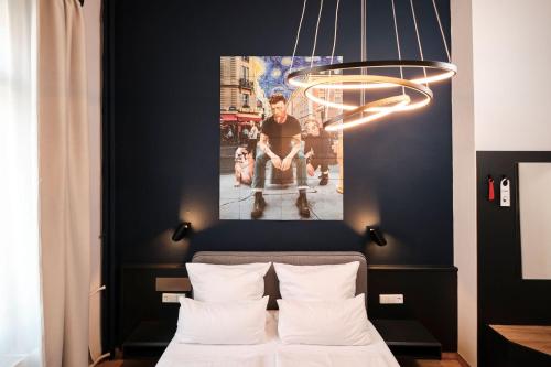 a bedroom with a bed with a picture on the wall at Karl - das City Hotel Konstanz in Konstanz