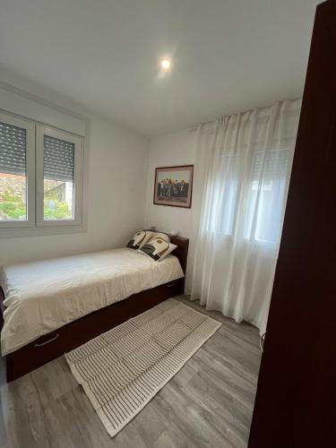 a bedroom with a bed and a window at Apartamento Solpor in A Guarda