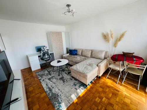 a living room with a couch and a table at Linden Alley Retreat Sarajevo with free parking in Sarajevo