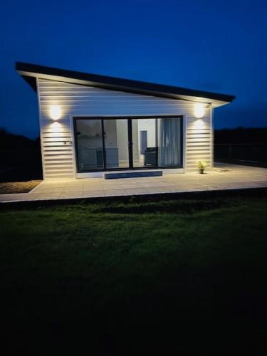 a small house with lights on the side of it at Kildare Holiday Apartments No 2 in Kildare