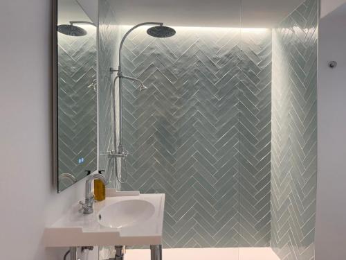 a bathroom with a sink and a shower at La Clé Boutique Hotel Old Town Marbella in Marbella