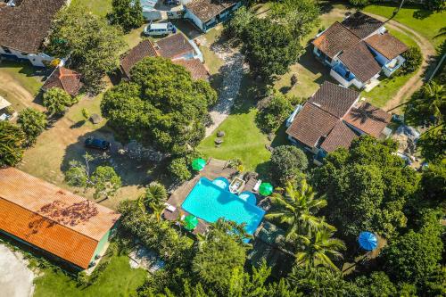 an aerial view of a house with a swimming pool at VELINN Pousada Bromelias in Ilhabela