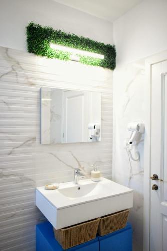 a bathroom with a white sink and a mirror at Pensiunea Pera in Jurilovca