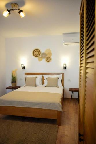 a bedroom with a bed and a butterfly on the wall at Pensiunea Pera in Jurilovca