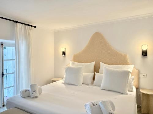 a bedroom with a large white bed with white pillows at La Clé Boutique Hotel Old Town Marbella in Marbella