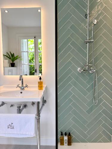 a bathroom with a sink and a mirror at La Clé Boutique Hotel Old Town Marbella in Marbella