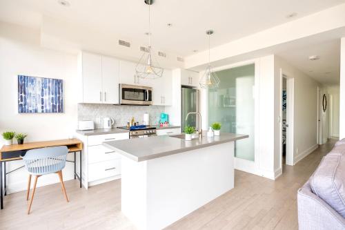 a kitchen with white cabinets and a counter top at Contemporary 3BR with Natural Light High Park North Nearest Intersection - Dorval Rd, in Toronto