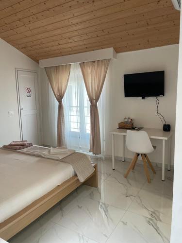 a bedroom with a bed and a desk and a television at Real home in Azzano San Paolo