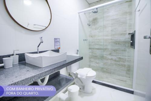 a bathroom with a sink and a mirror at VELINN Pousada Angra Sunset in Angra dos Reis