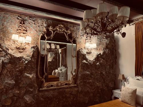 a bedroom with a large mirror on the wall at Conacul Coroanei Luxury Boutique Hotel in Bucharest