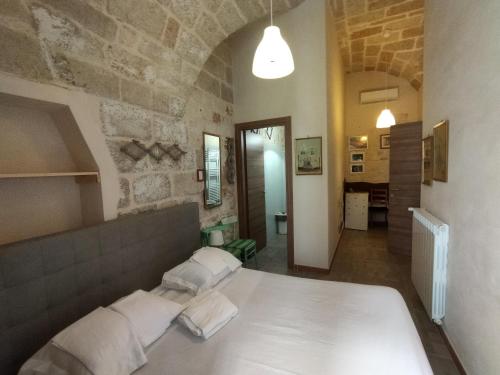 a bedroom with a large bed with two pillows at Dimora delle Badesse in Conversano