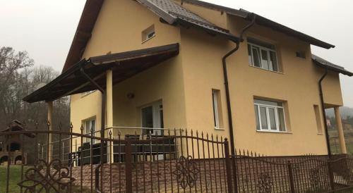 a house with a fence in front of it at Vila Costea in Geoagiu Băi