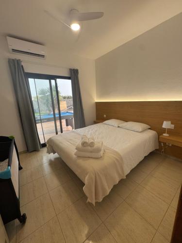 a bedroom with a bed with two towels on it at Villa Sarah in Playa Blanca