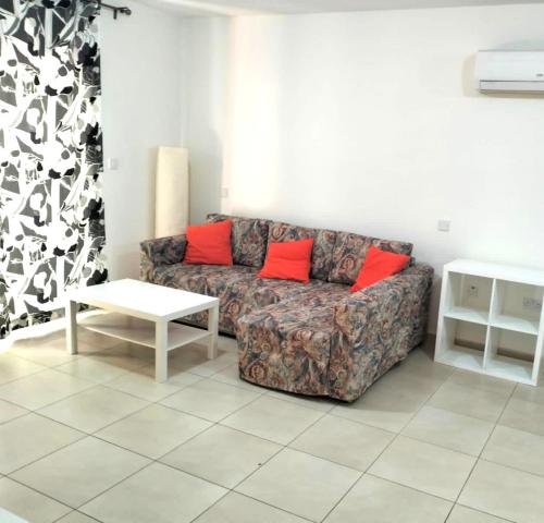 a living room with a couch and a table at Regina by the Sea in Limassol