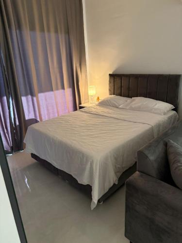 a bedroom with a large bed and a couch at CEASAR RESORT STUDIO Consus in Aglantzia
