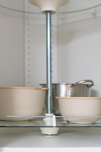 a group of bowls on a shelf in a kitchen at 15m to NY Cozy Relaxing Home in Hackensack