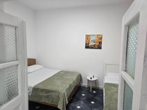 a small bedroom with a bed and a window at Eva & Resul apartments in Ilias