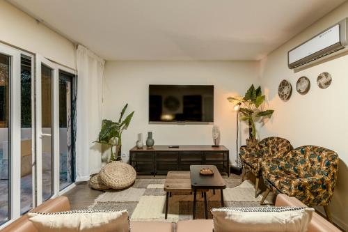 a living room with a couch and a tv at Cortes Reais Guesthouse By All2gether in Lisbon