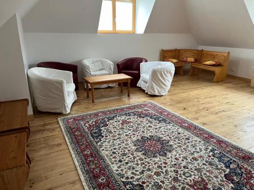 a living room with furniture and a rug on the floor at La Maison Garrap dans le val d'Azun in Arrens-Marsous