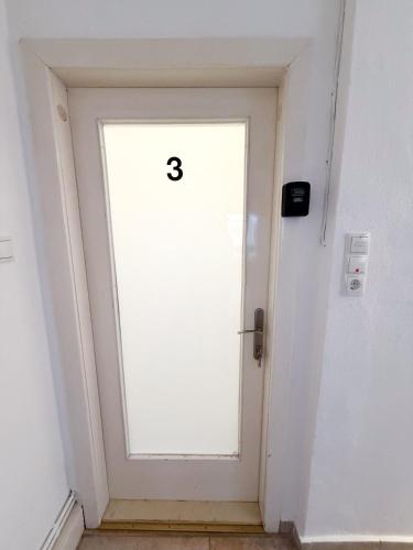 a white door with the number eight on it at Danube Holiday Rooms in Krems an der Donau