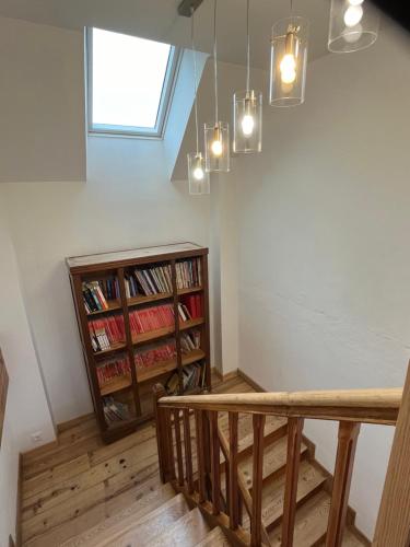 a room with a staircase and a book shelf at La Maison Garrap dans le val d'Azun in Arrens-Marsous