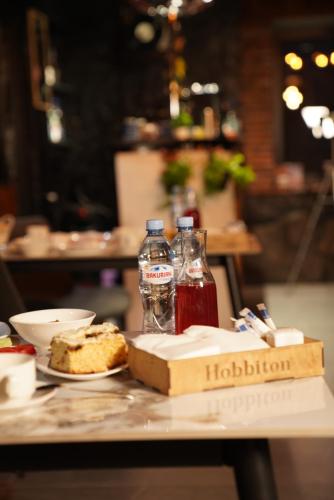 two bottles of water and a box of bread on a table at Hotel Hobbiton near Vardzia Caves in T'mogvi