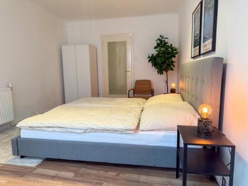 a bedroom with a bed and a side table at Danube Holiday Rooms in Krems an der Donau