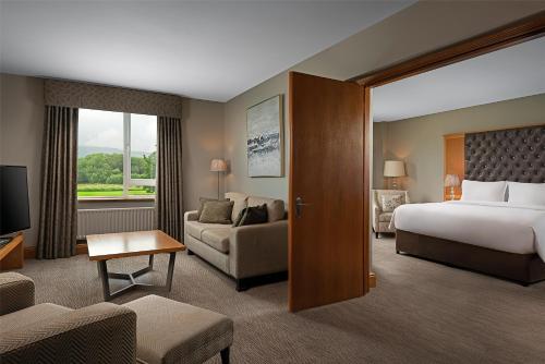 um quarto de hotel com uma cama e um sofá em Radisson BLU Hotel and Spa, Limerick em Limerick
