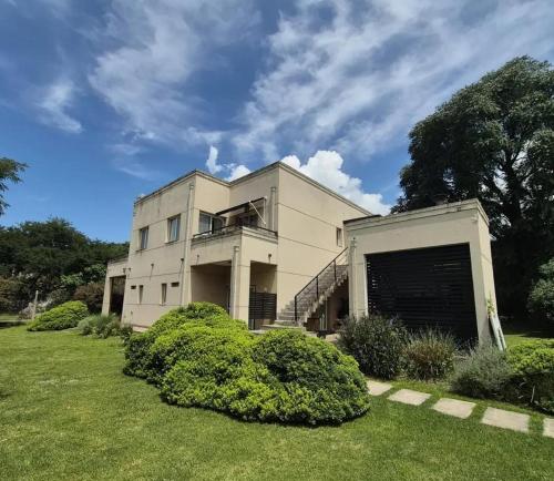 a large white building with a garage at Apart Boutique Macedonia in San Lorenzo