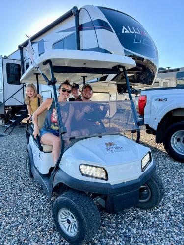a group of people sitting in a golf cart at Verde Ranch RV Resort in Camp Verde