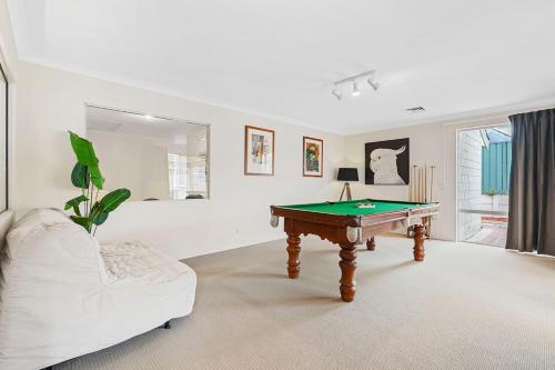a living room with a pool table and a couch at The Grand Family Mansion 5BR with Pool Table, BBQ in Perth