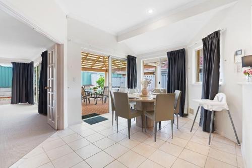 a dining room with a table and chairs at The Grand Family Mansion 5BR with Pool Table, BBQ in Perth