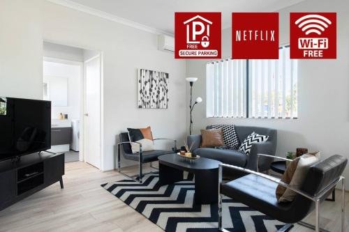 a living room with a couch and a tv at Chic Exec 2bdr 2bath -River,FREO,Parking,AC in Perth