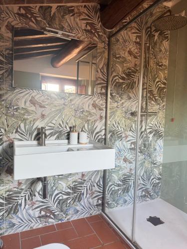 a bathroom with a sink and a wall mural at La Mora Affittacamere in Tuoro sul Trasimeno