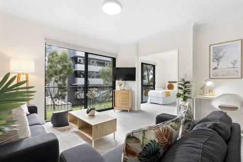 a living room with a couch and a table at East Perth Family Zen CATBus, CBD,ElizabethQuay in Perth