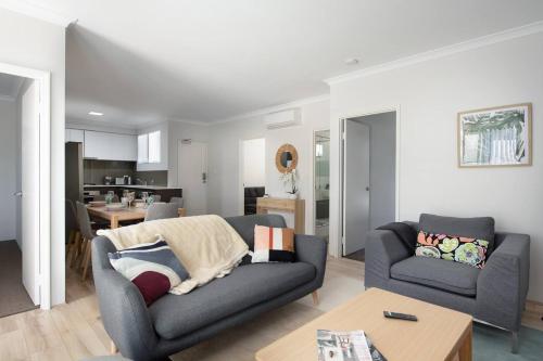 a living room with a couch and a table at Modern Cozy spacious 3 bdrm 2bath,FREO,Parking,AC in Perth