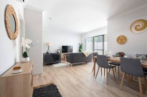 a dining room and living room with a table and chairs at Modern Cozy spacious 3 bdrm 2bath,FREO,Parking,AC in Perth