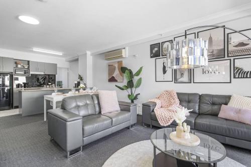 a living room with a couch and a table at City Living Retreat - 2BR Apartment in East Perth in Perth