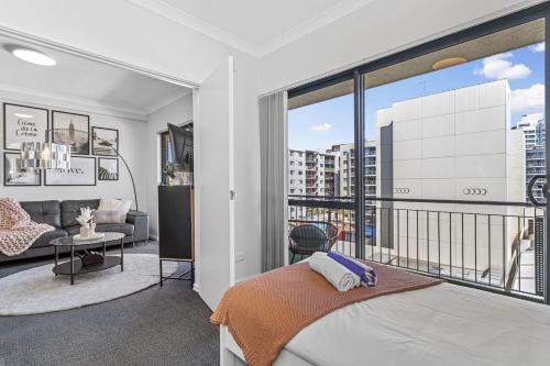 a bedroom with a bed and a living room at City Living Retreat - 2BR Apartment in East Perth in Perth